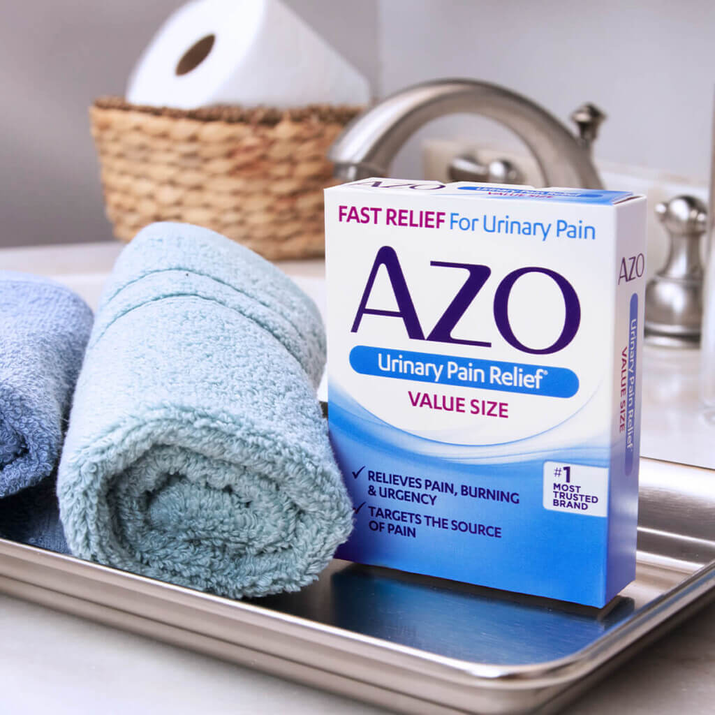 AZO Urinary Pain Relief next to two blue towels