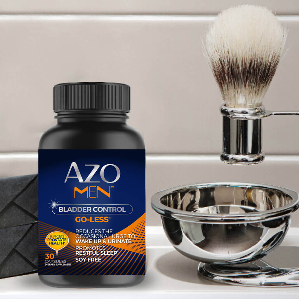 AZO Men Bladder bottle next to a shaving bowl and brush