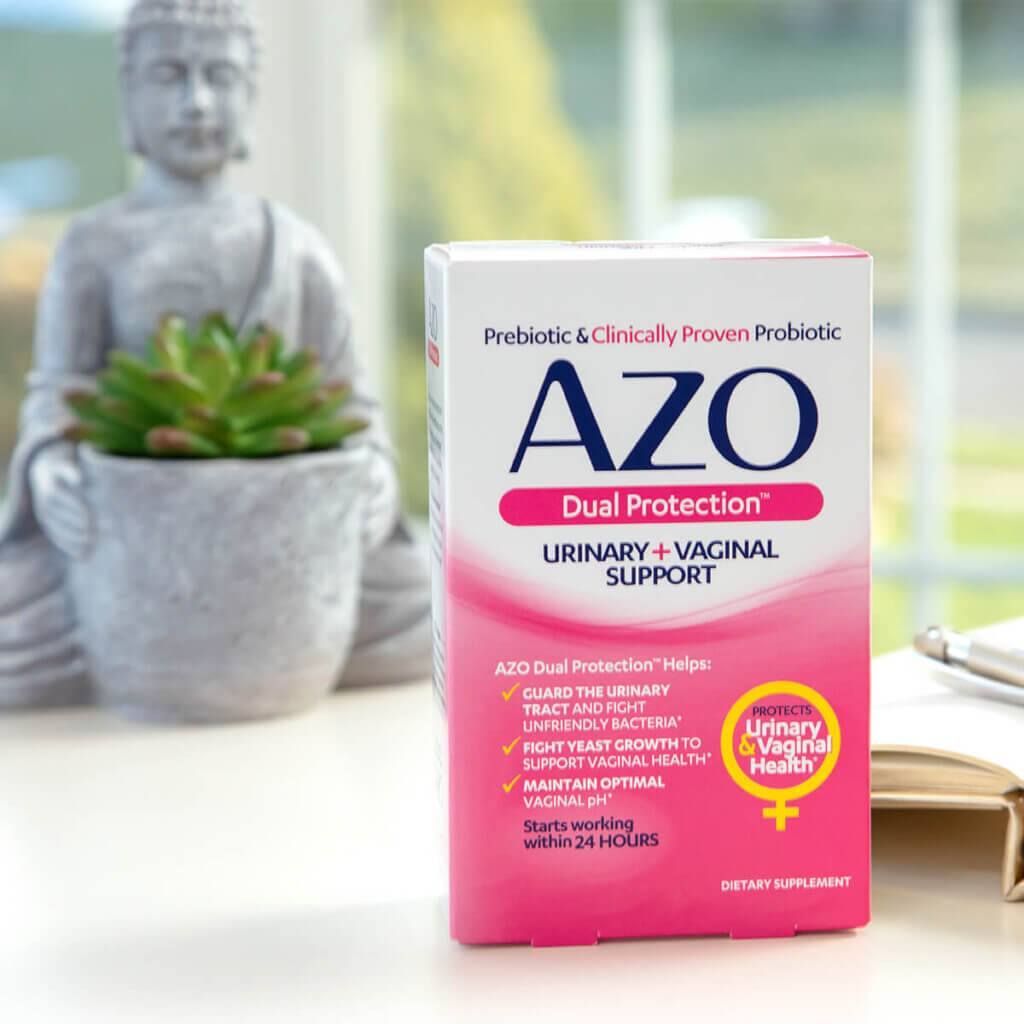 AZO Dual Protect Benefits box in front of a budda statue